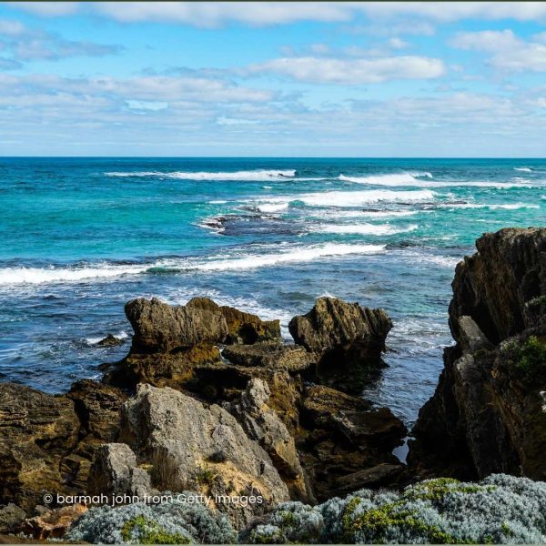 Overlooking rocks to blue green ocean